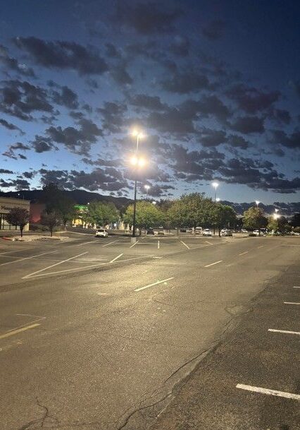 Commercial parking field lit by LED pole lighting at dusk